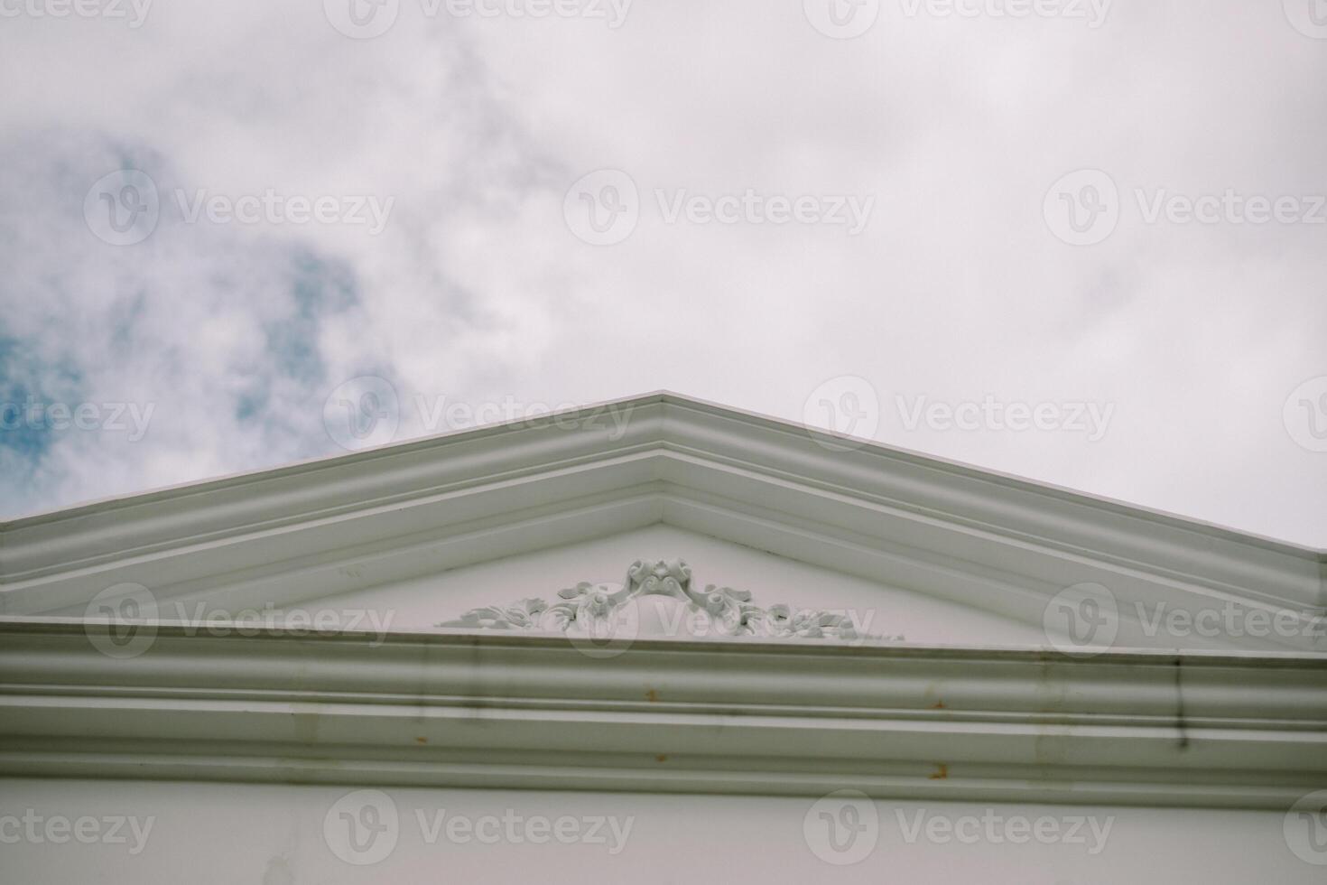 White triangular pediment with ornate details so nice so photo