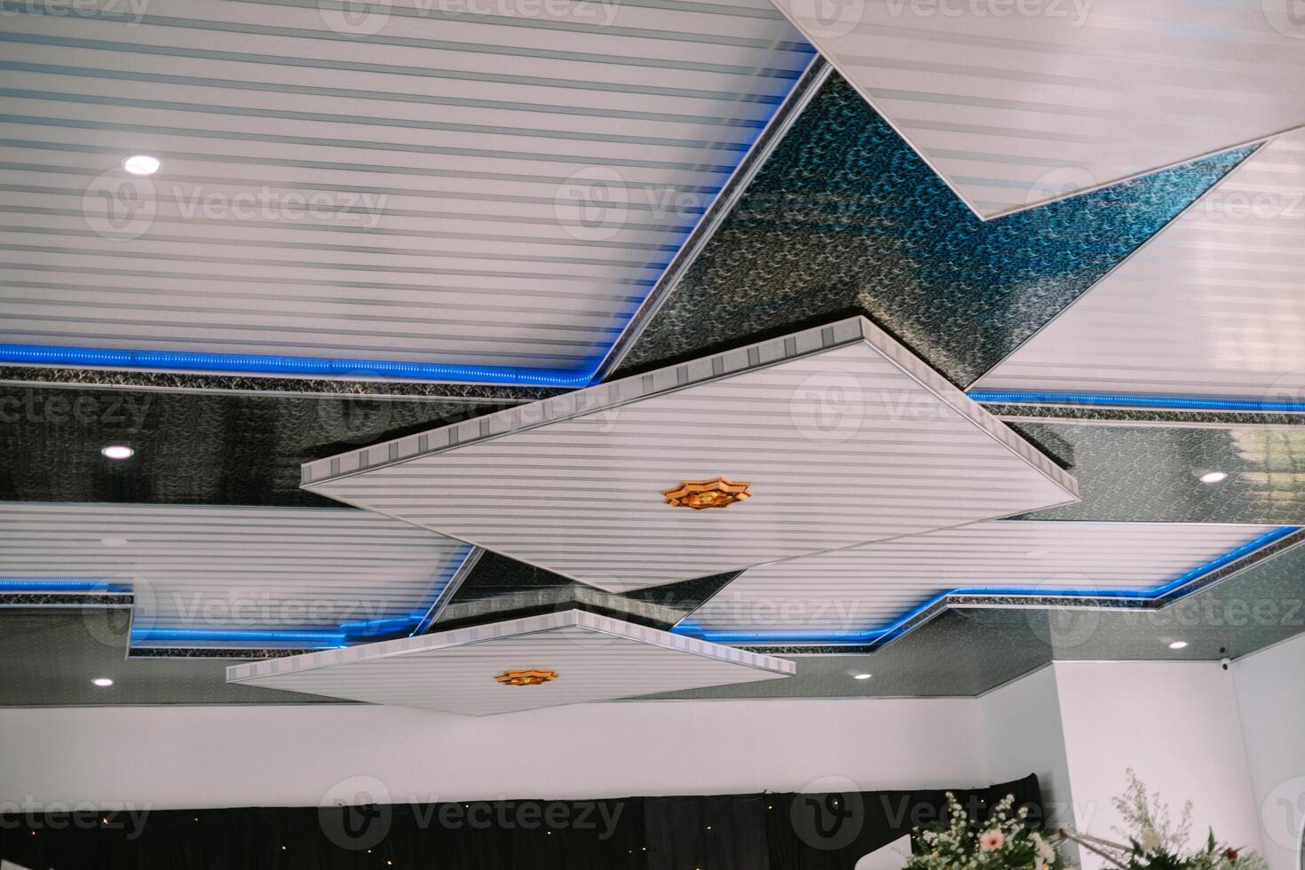 A contemporary ceiling featuring geometric panels, integrated lighting, and a sleek so nice photo