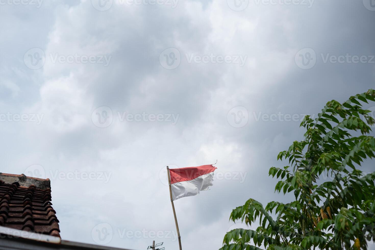 The Indonesian red and white flag waves proudly under a cloudy sky so nice photo