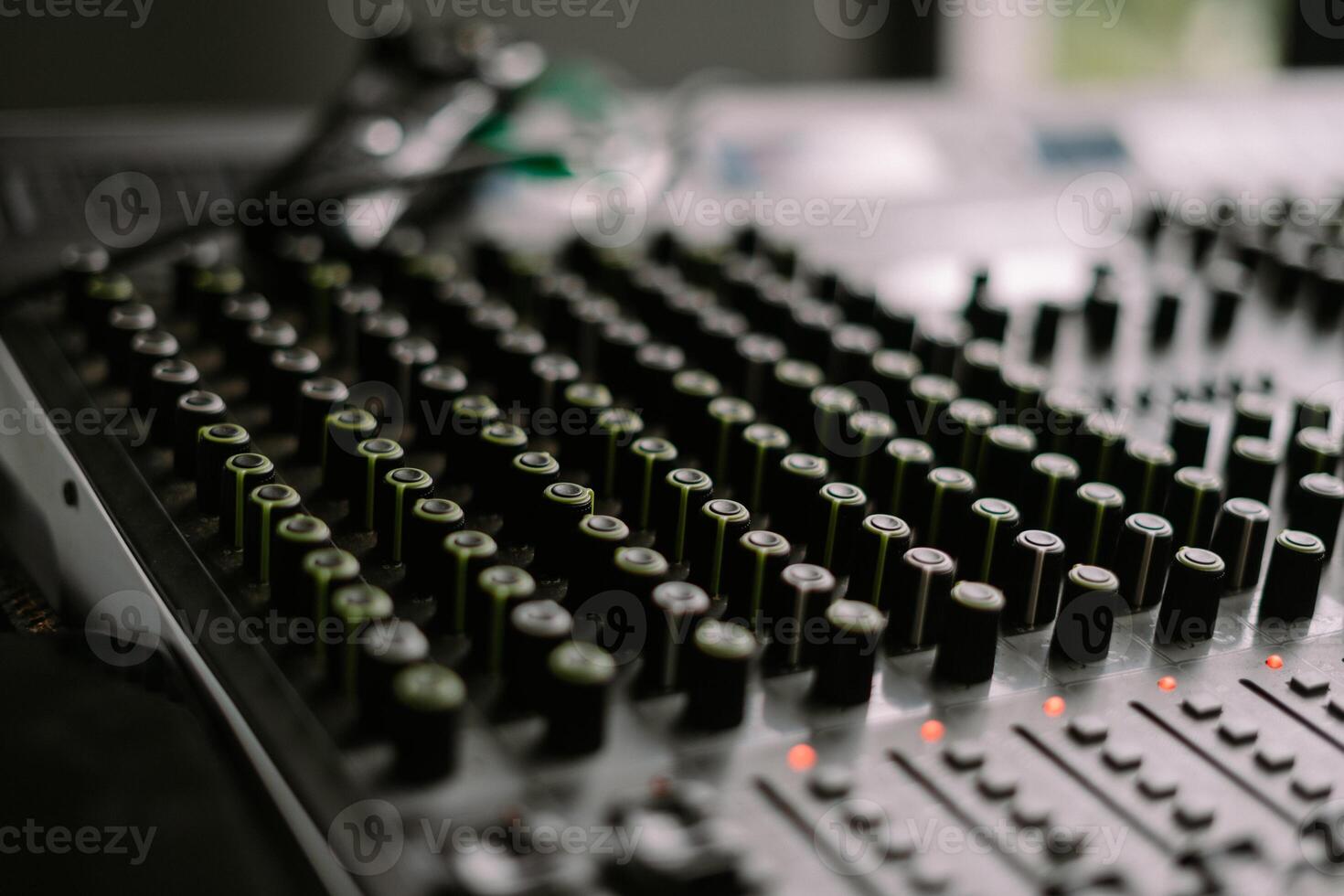 Close-up view of a sound mixer with numerous knobs and faders, ideal for music production so nice photo