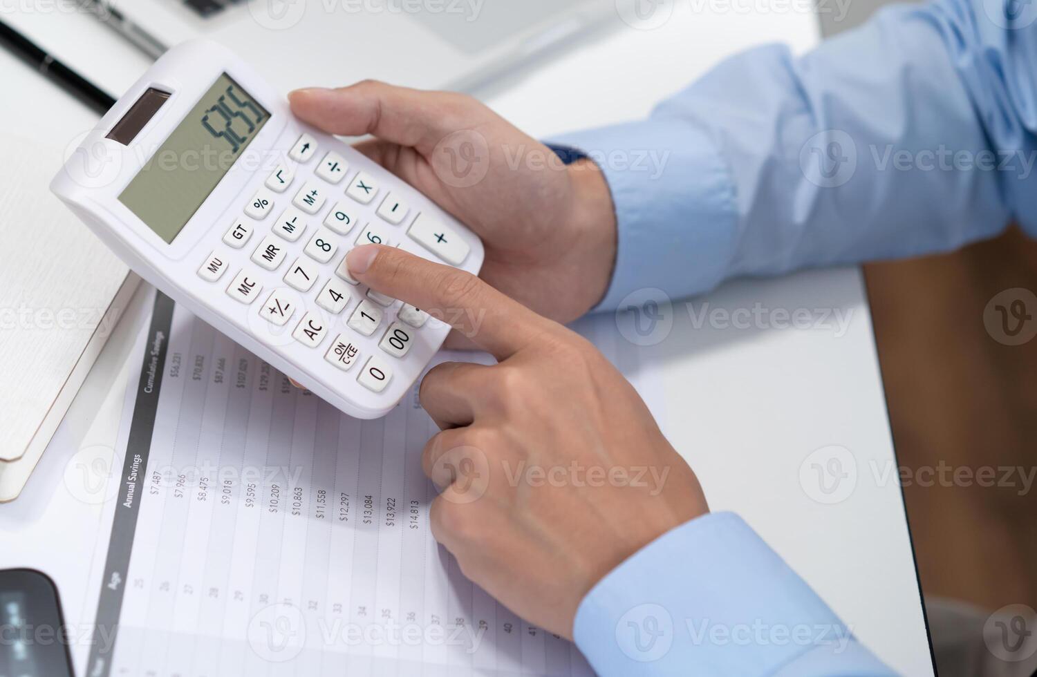 Businessman Saving money analyzing investment charts and pressing calculator buttons over documents. Accounting Concept photo