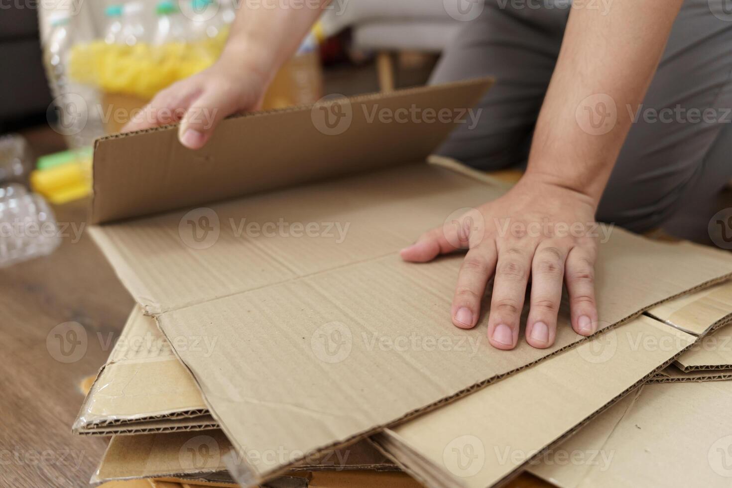 Home recycle eco zero waste concept Man using recycle paper box. Stacking brown cardboard box eco friendly packaging made of recyclable raw materials. photo