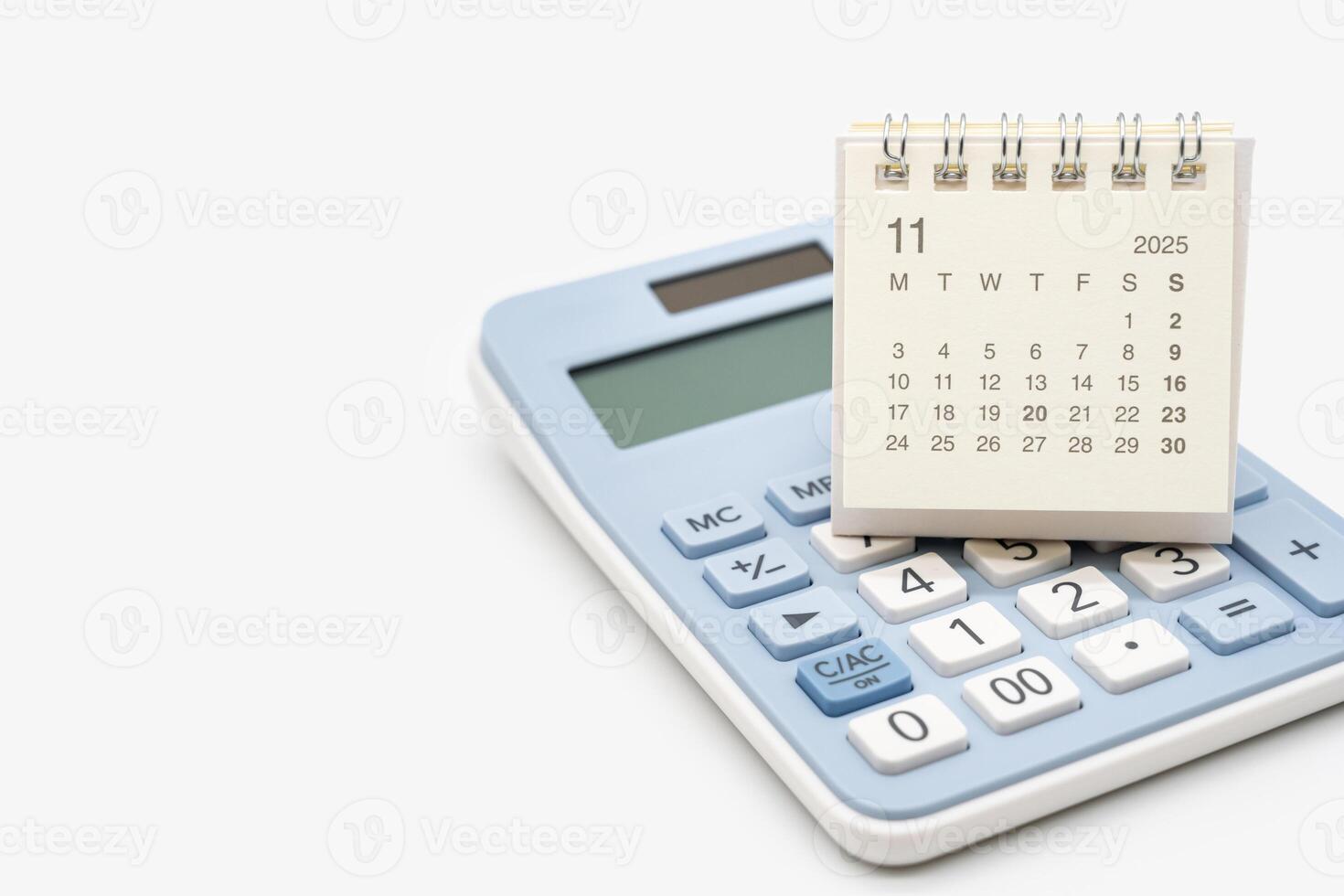 Desk calendar for NOVEMBER 2025 on calculator. Calendar concept with copy space. 2025 NOV calendar. calculator and forecast for finances in 2025. Money, Budget, investment and financial. photo
