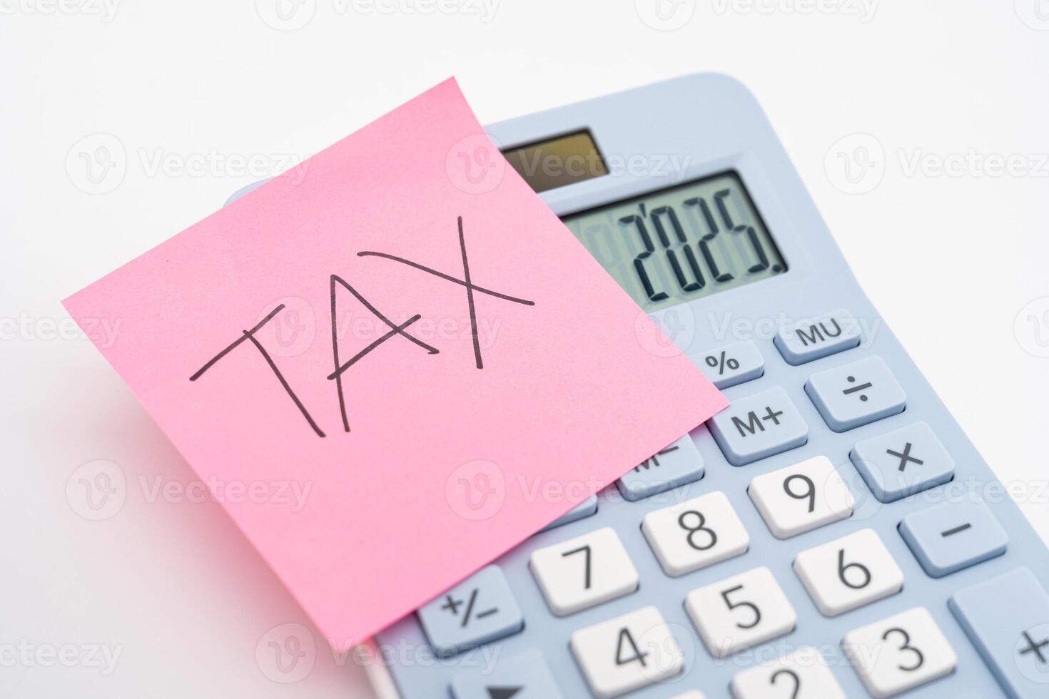 Tax Sticky note on calculator, forecast for finances in 2025. Budget, tax, investment, financial, savings. photo
