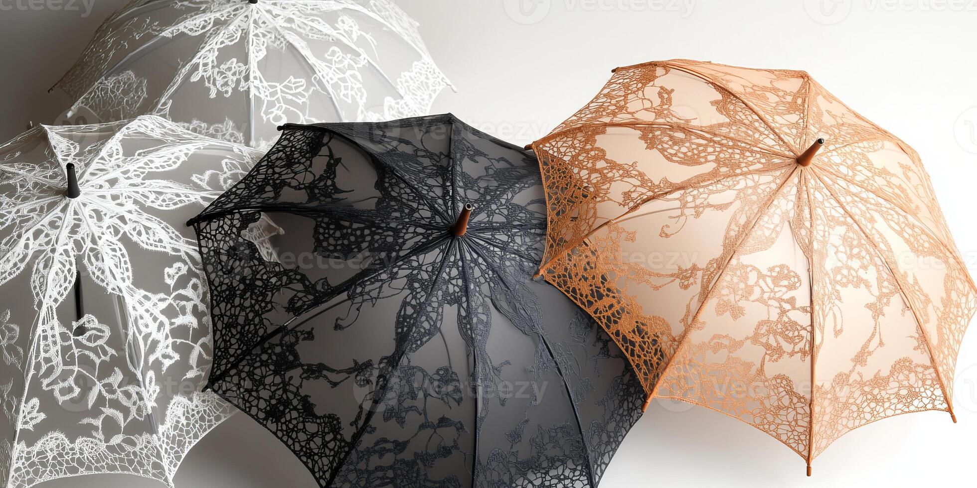 Three umbrellas with lace designs are displayed on a white background photo