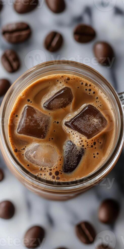 A mug of coffee with ice cubes in it photo