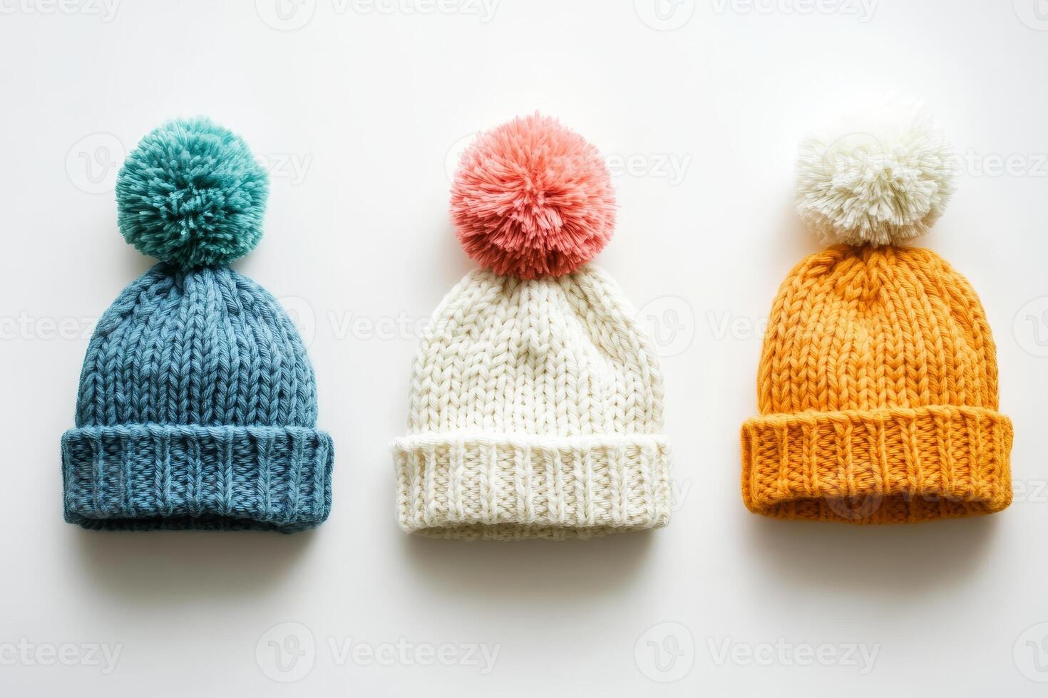 Colorful Knitted Winter Hats with Pom-Poms on White Background photo