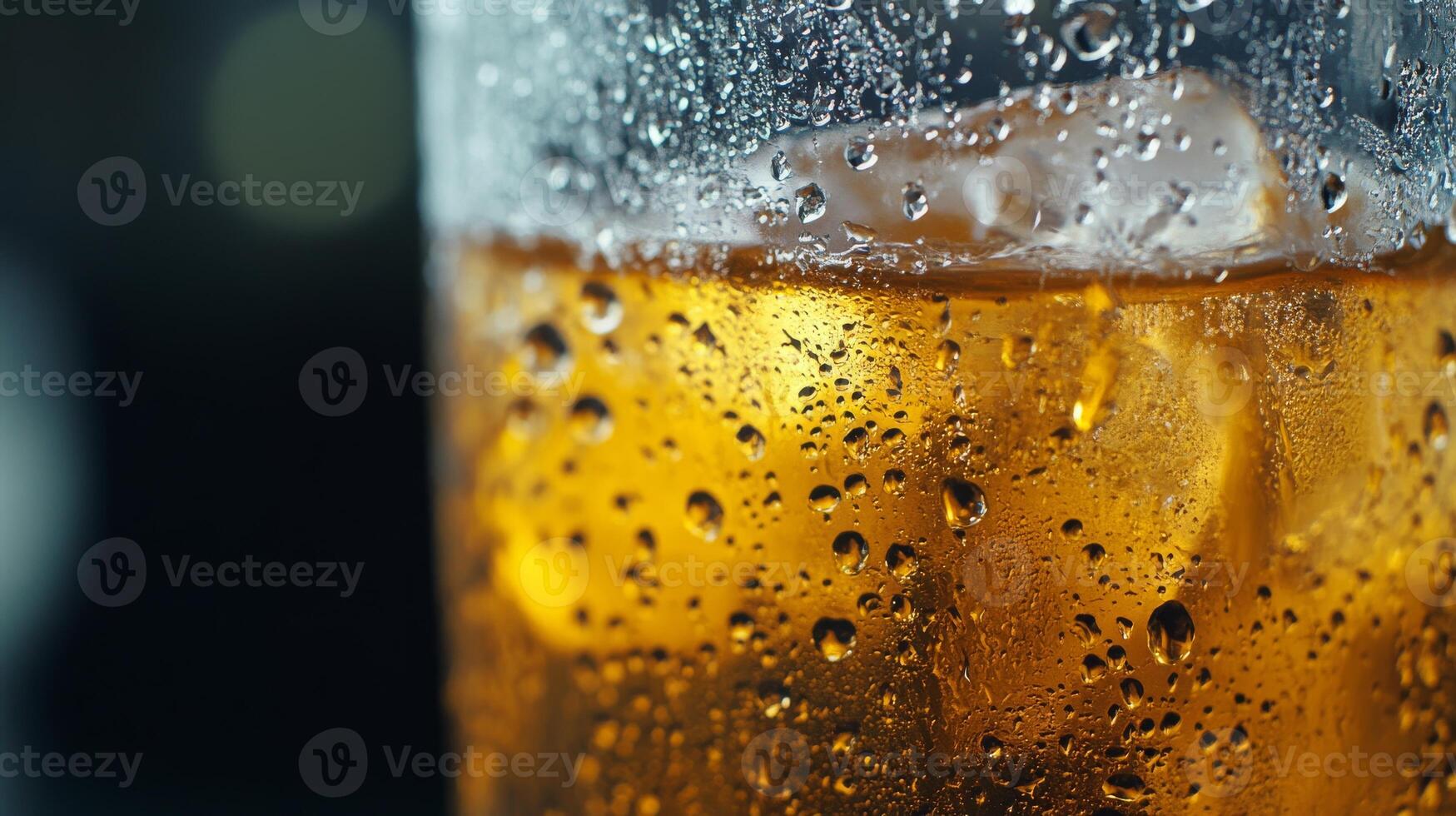 A glass of beer with ice cubes in it photo