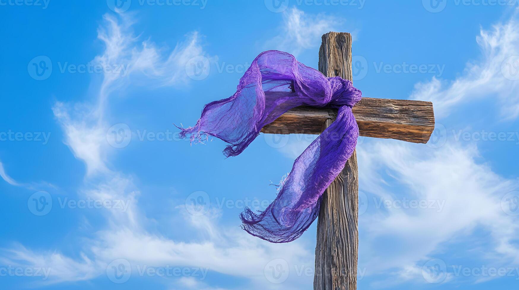 Purple scarf is tied to a wooden cross photo