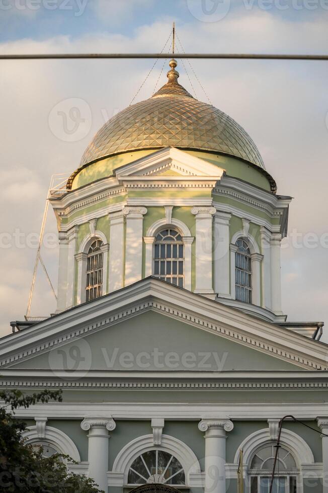A clock tower in front of a building photo