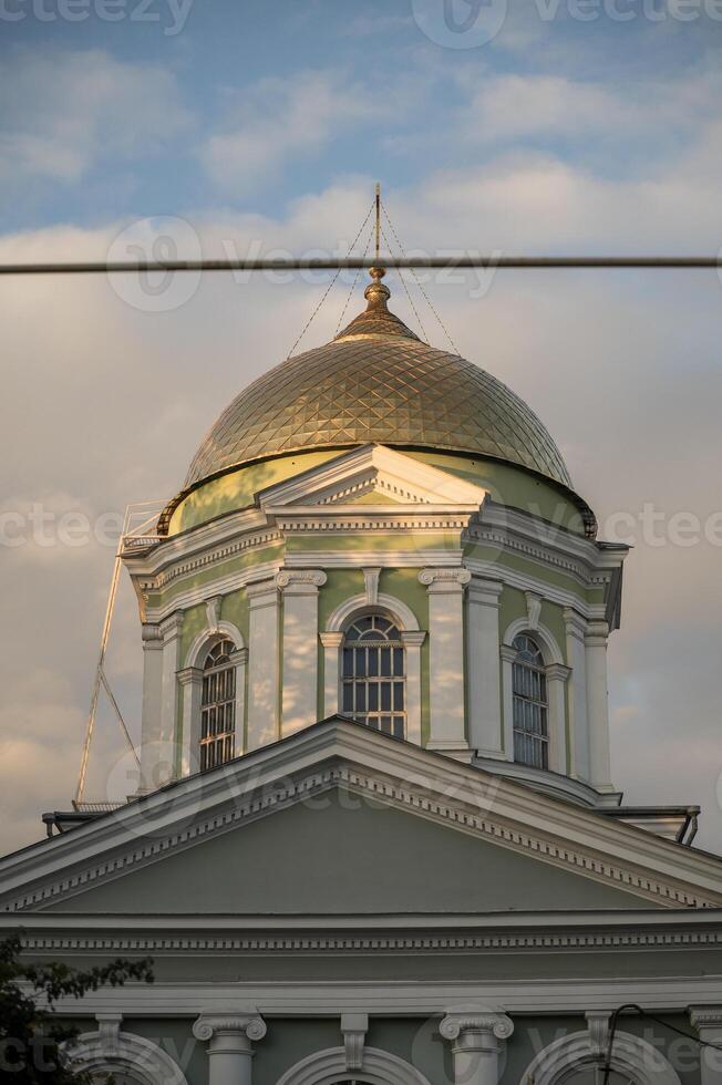 A clock tower in front of a building photo