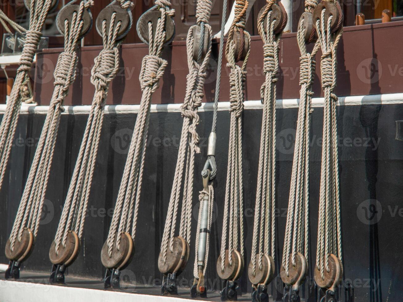 A row of ropes hanging on a ship photo