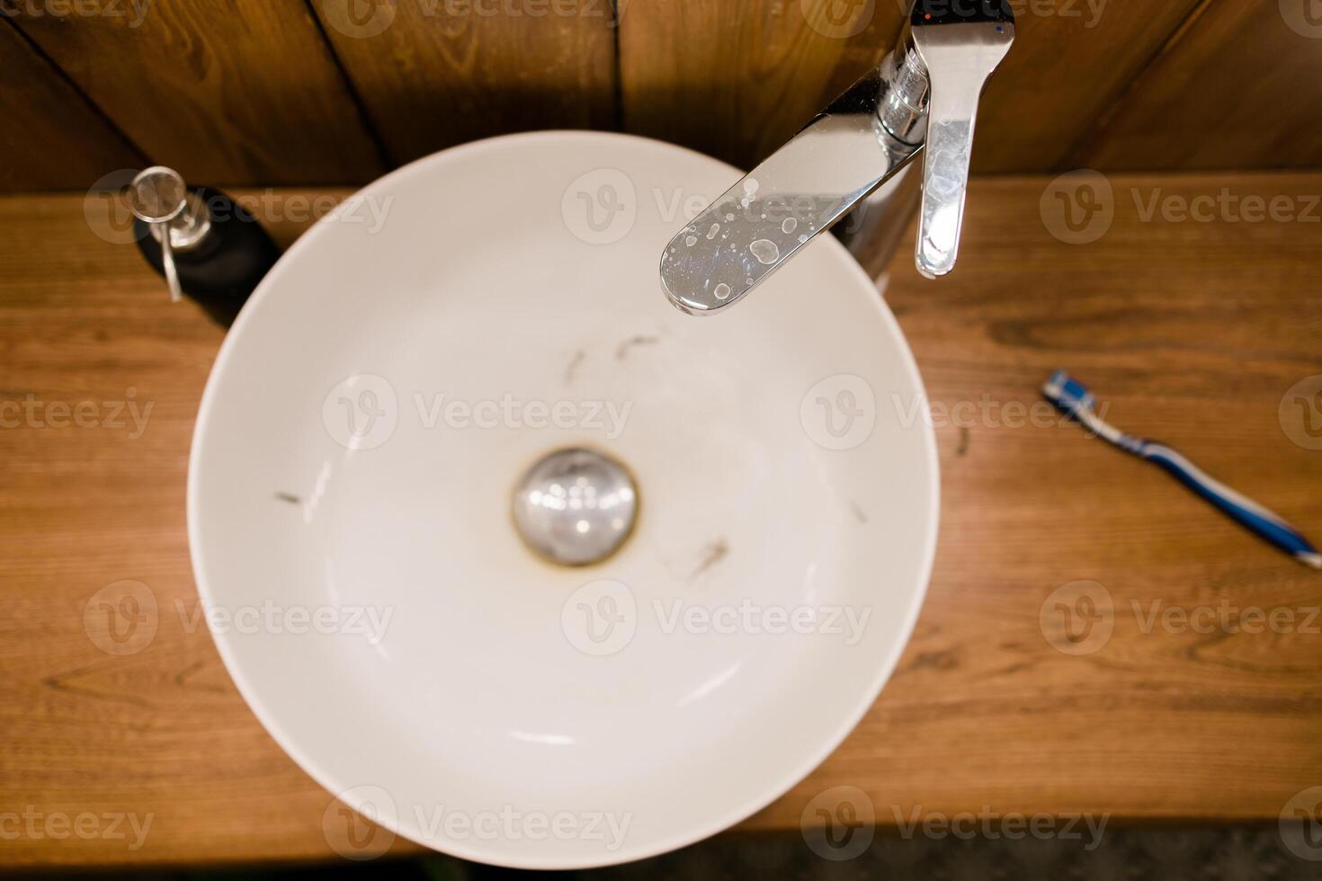 Water tap with dirty sink close up. chrome faucet wash basin. Hygiene and Cleaning hands and messy home concept. photo