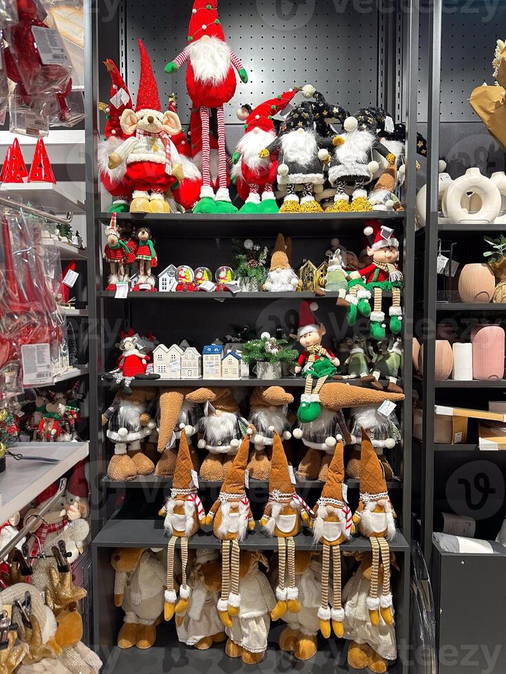 Shelves in Christmas store adorned with whimsical gnome figures and festive holiday decorations. Holidays sale photo