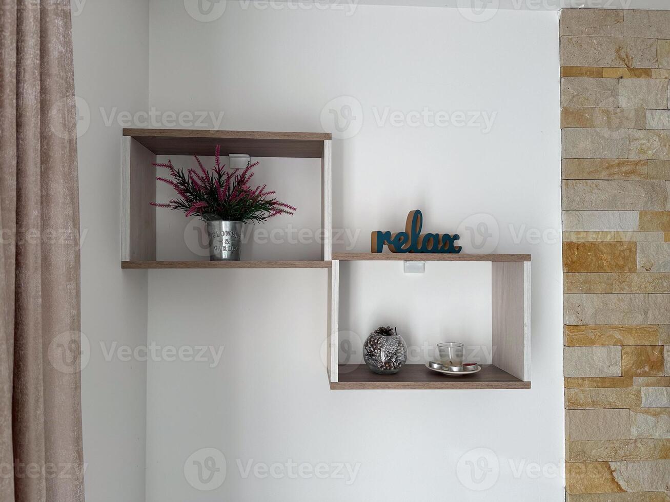 Minimalist wall shelf with a decorative flower pot and a teal relax sign. The background features a neutral wall with subtle textures and a soft curtain. Cozy and calming ambiance photo