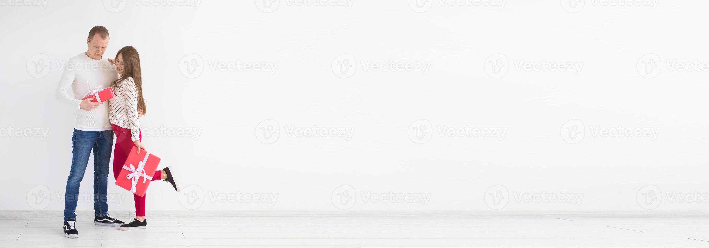 Banner birthday, holidays and valentine's day concept - happy young man and woman with gift boxes on white background with copy space photo