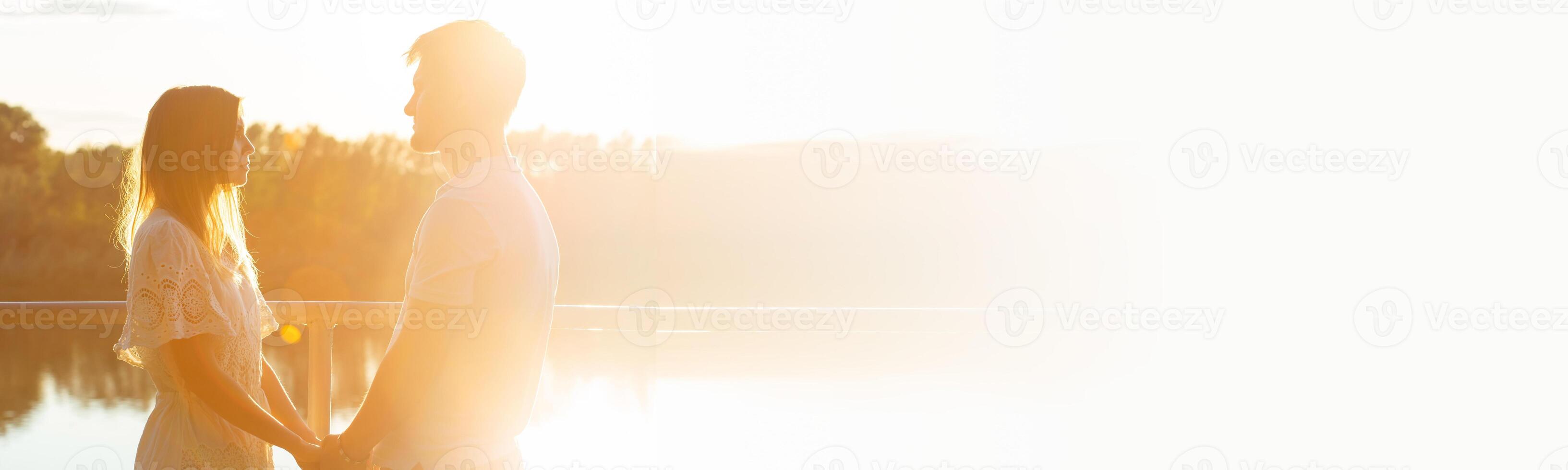 Banner Valentines day - Wonderful young couple hug and enjoy life together with natural outdoor leisure activity lifestyle on nature and the sunset in backlight copy space photo