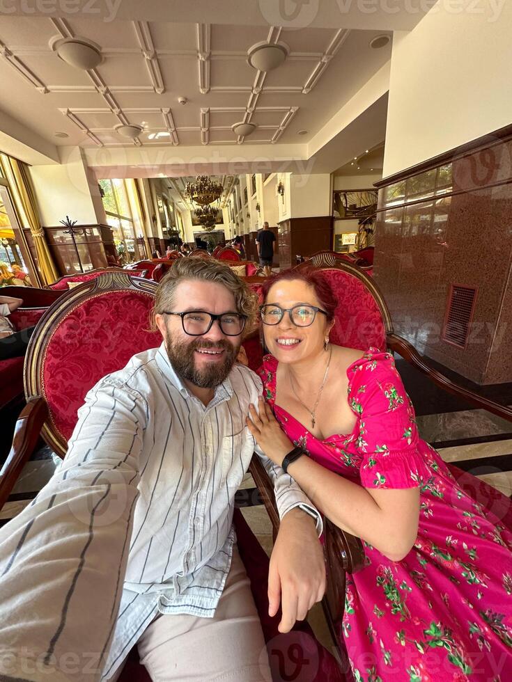Smiling couple enjoying their time together in a luxurious and elegant hotel lounge. Relationship, love, Valentines day and ornate interior design concept photo