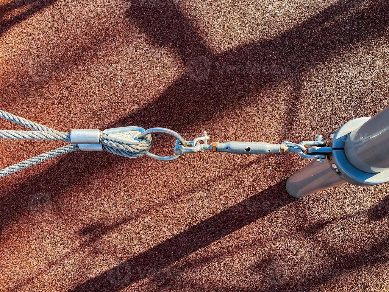 Closeup of an electric blue cable attached to a metal pole photo