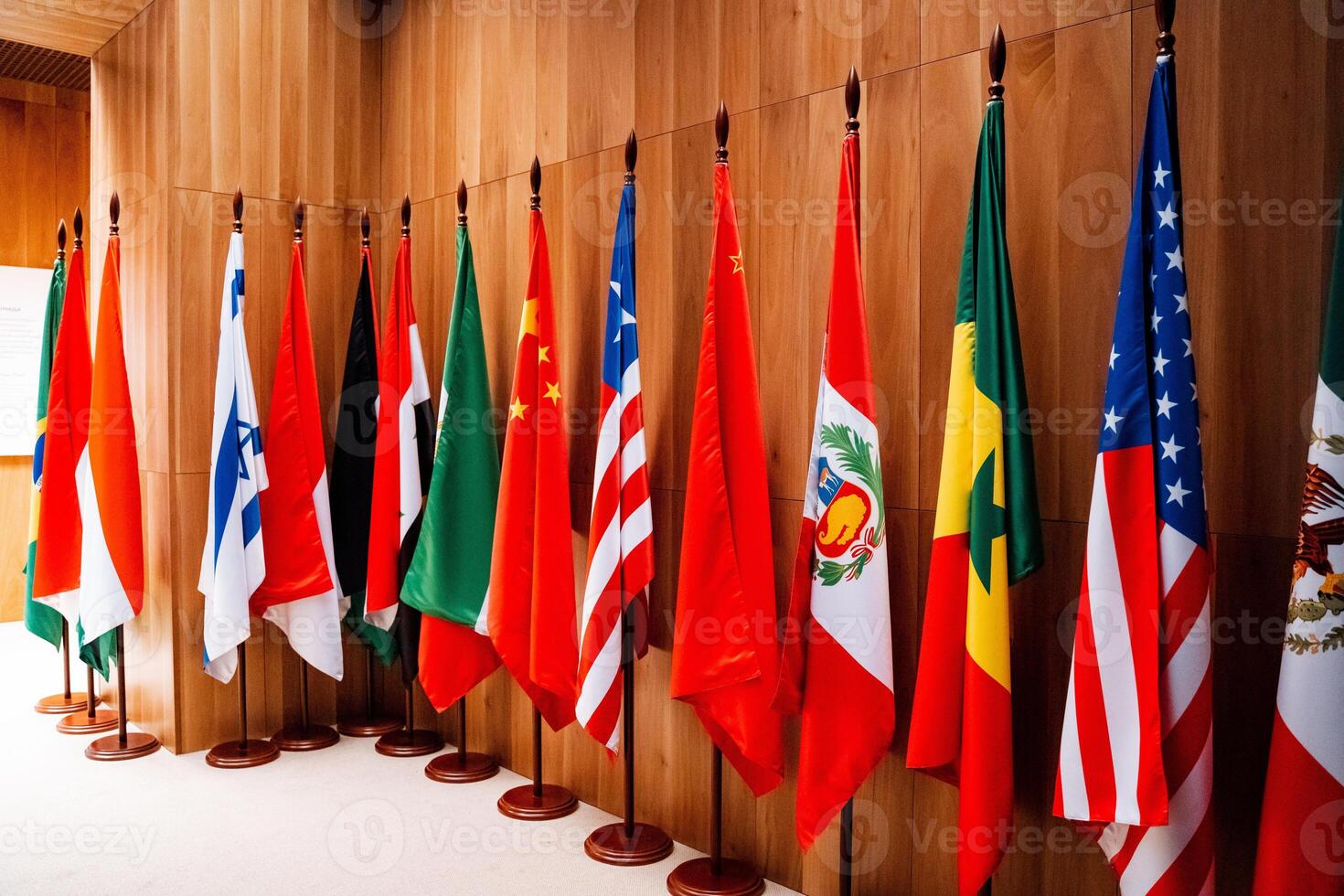 A row of flags decorates the wooden wall of the event room photo