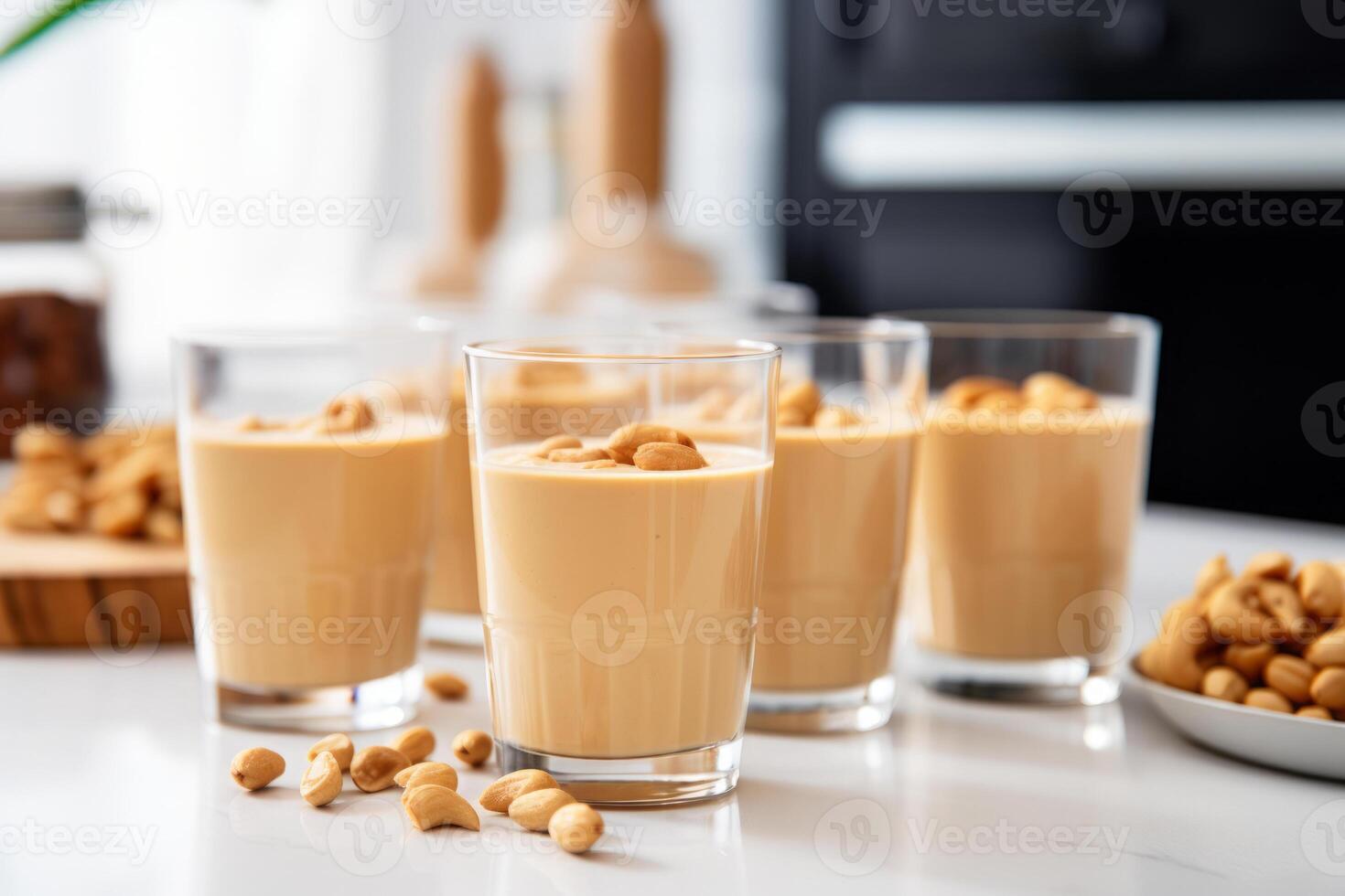 Peanut butter protein smoothie in glasses in white modern kitchen photo