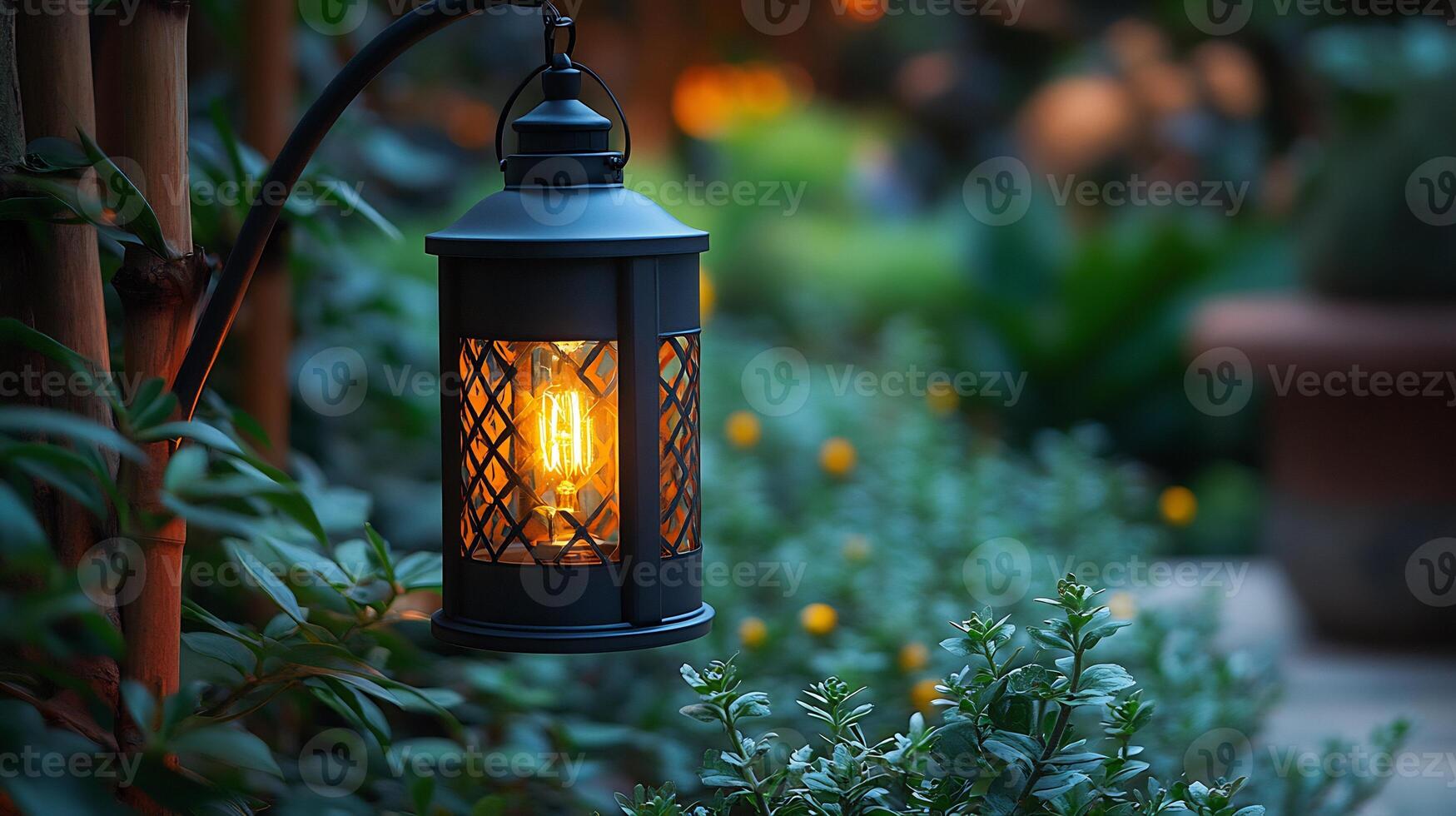 Rustic outdoor lantern glows warmly casting soft light onto surrounding greenery while metal frame adds charm and enhances the cozy outdoor setting photo