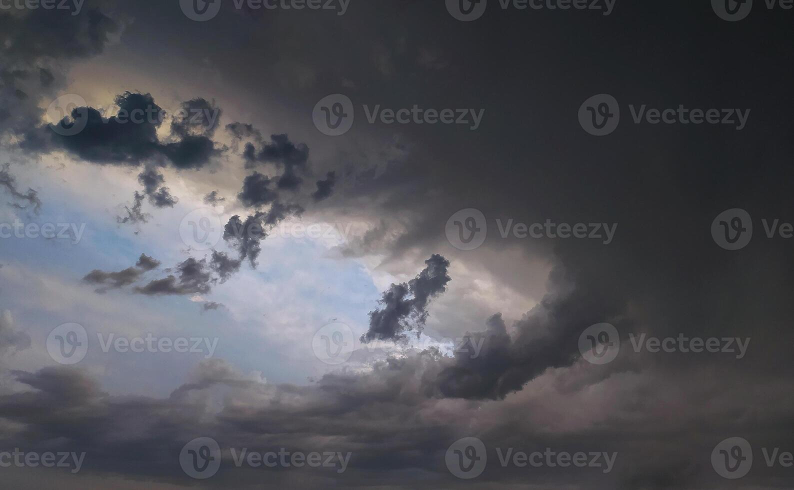 Dramatic cloud fills the sky during an overcast evening, hinting at an approaching storm photo