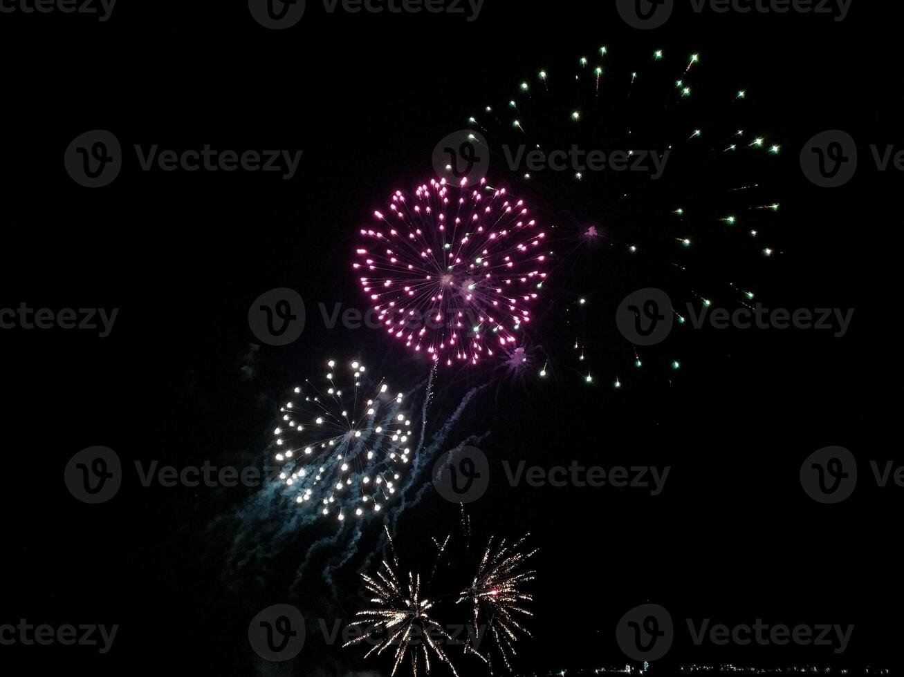 Stunning fireworks display against a deep black night sky. photo