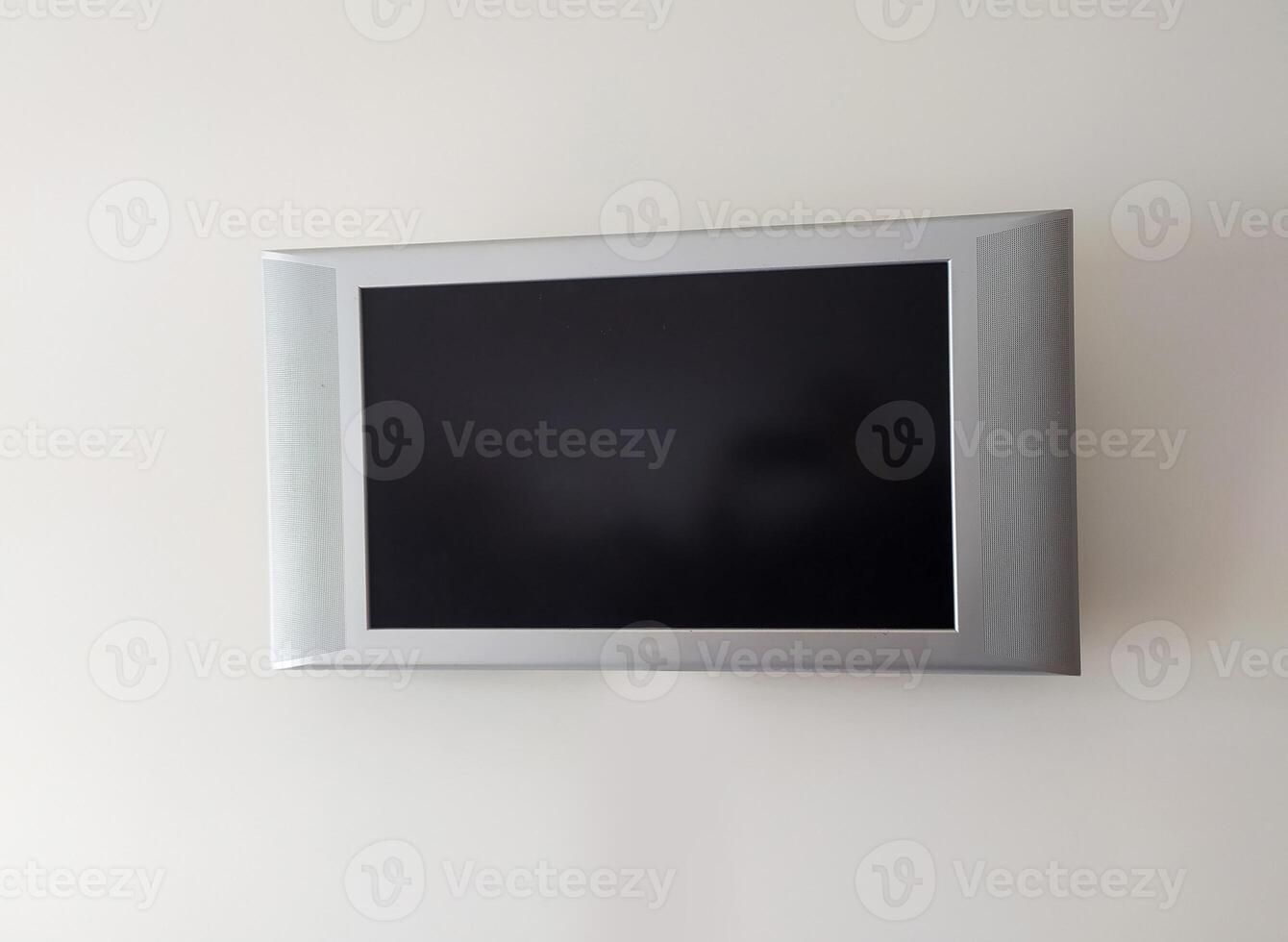 Sleek silver flatscreen TV mounted o photo