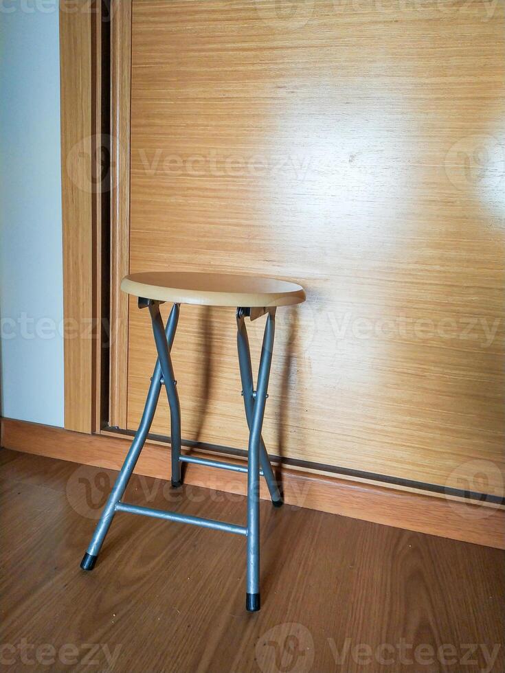 Compact, lightweight, foldable stool with a light wood top and silver frame. Perfect for small spaces, extra seating, or as a side table. Ideal for home, office, or travel. photo