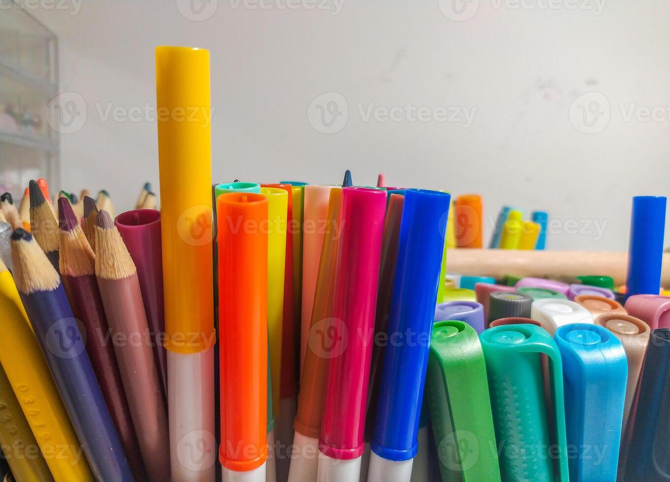 Closeup shot of colorful markers and pencils arranged together. Vibrant hues and textures create a visually appealing image perfect for education, art, or backtoschool themes. photo