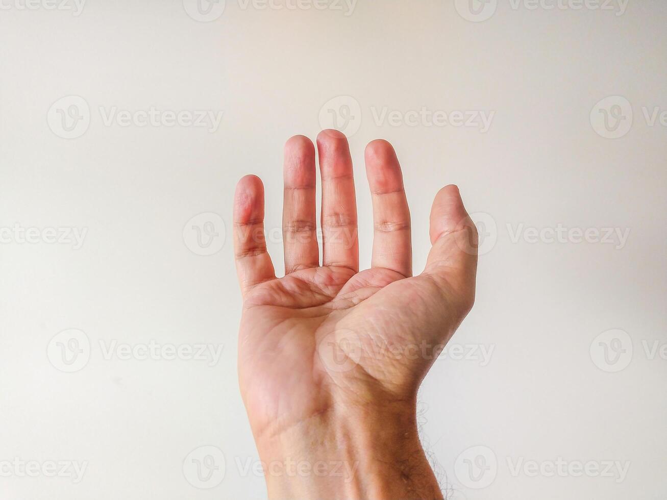 Closeup of a male hand, palm up, against a neutral background. Perfect for concepts of giving, receiving, or helping. Ideal for websites, apps, and presentations needing a clean, simple image. photo