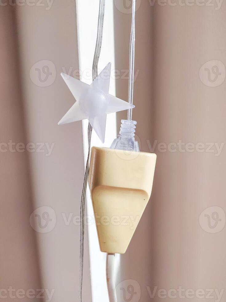 creamcolored electrical plug with a string photo