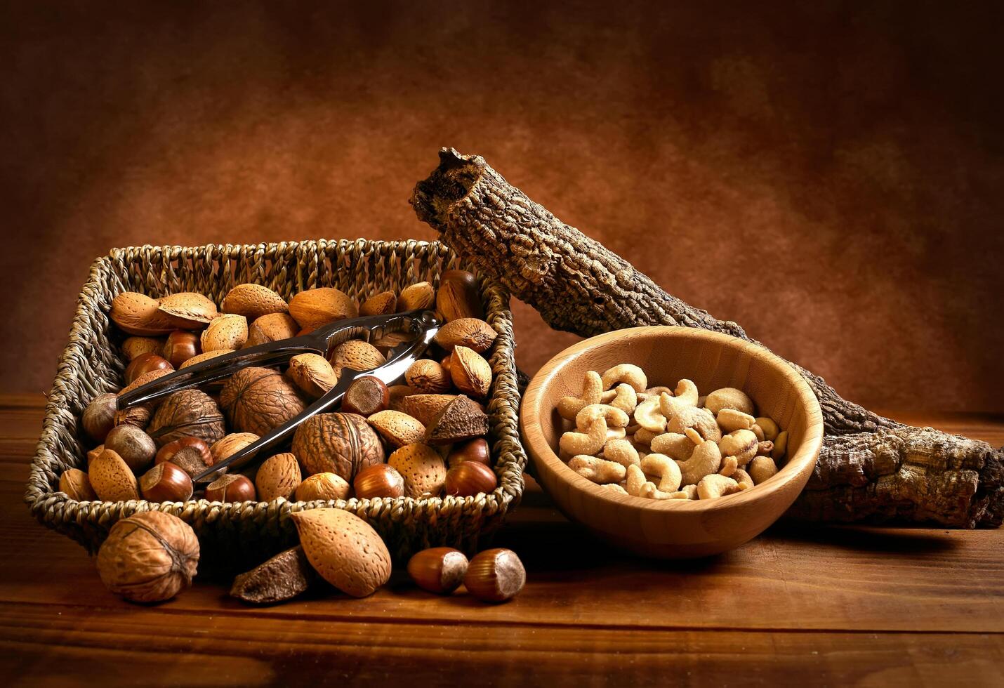 A basket of nuts and a wooden stick photo