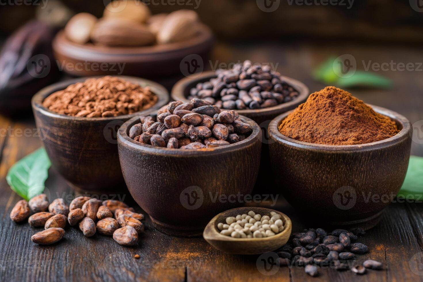Cocoa beans, powder, butter and nibs displayed in wooden bowls photo