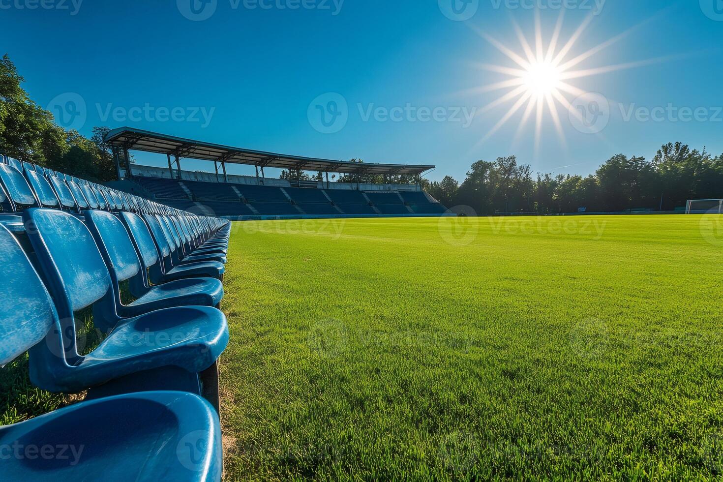 Empty blue seats in a football stadium under the summer sun photo