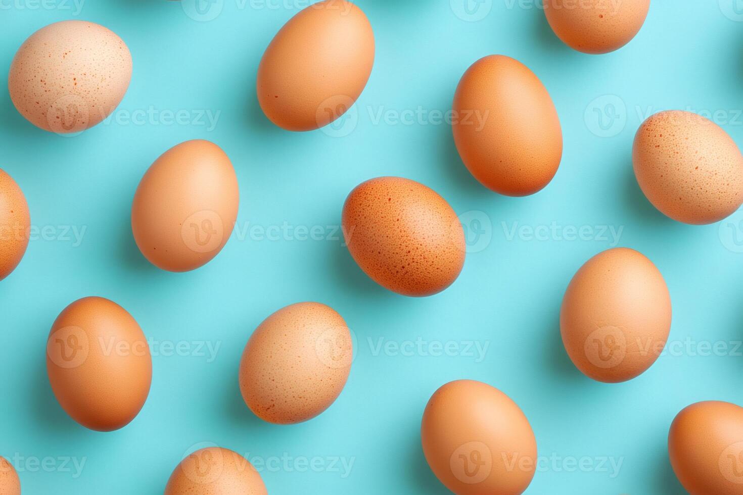 Chicken eggs forming repetitive pattern on light blue background photo