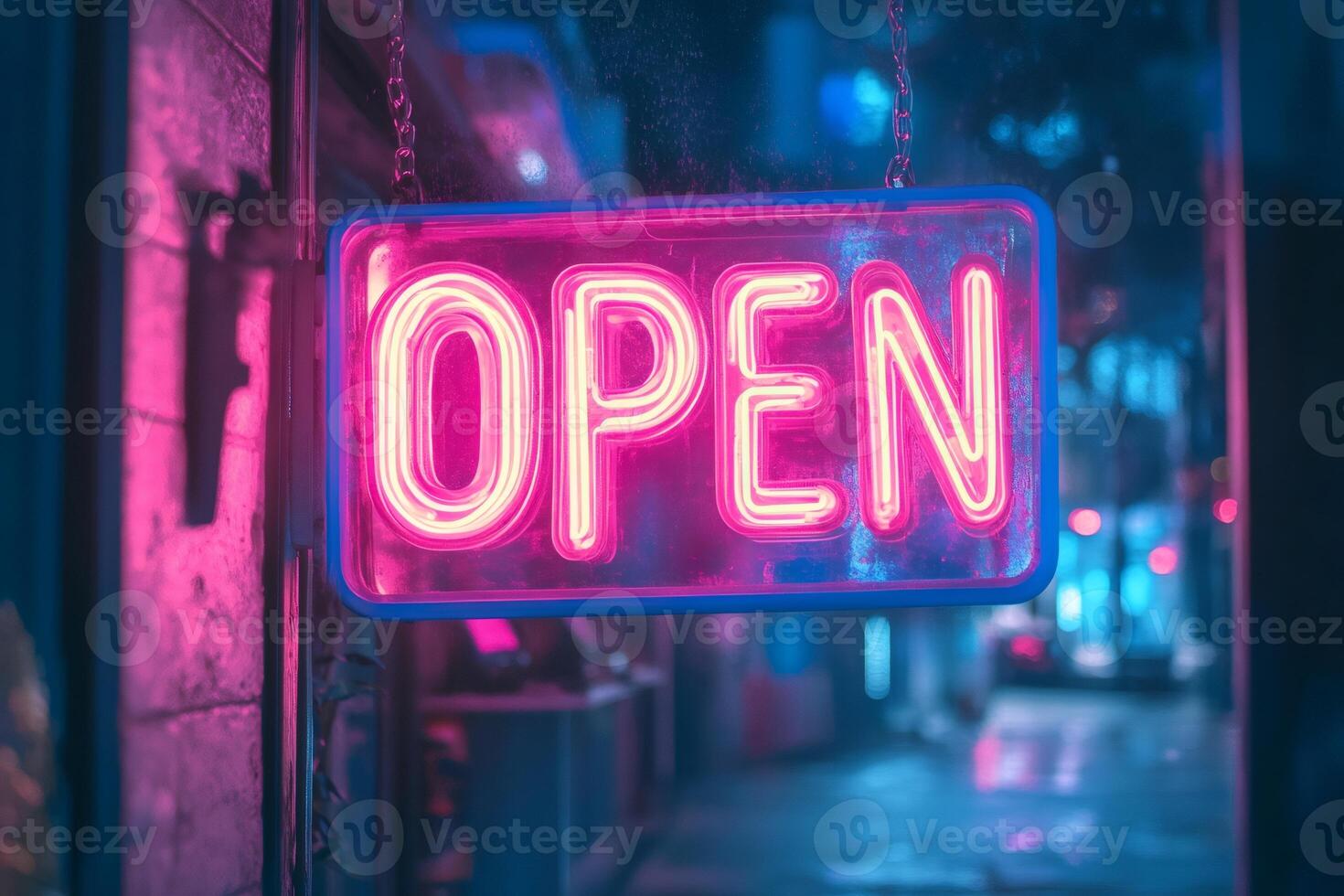 Bright pink neon open sign hanging in a window at night photo