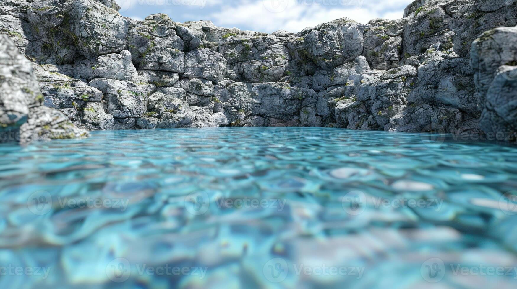 A peaceful pool of clear blue water surrounded by rocky cliffs photo