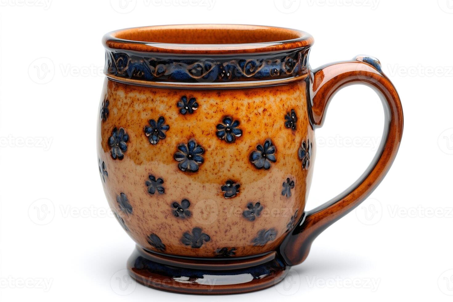 Brown ceramic mug with blue floral pattern standing on white background photo