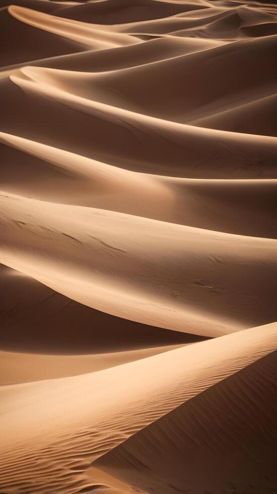 Smooth sand dunes in warm light form a vertical composition, with a blank sky or soft textures perfect for text placement. photo