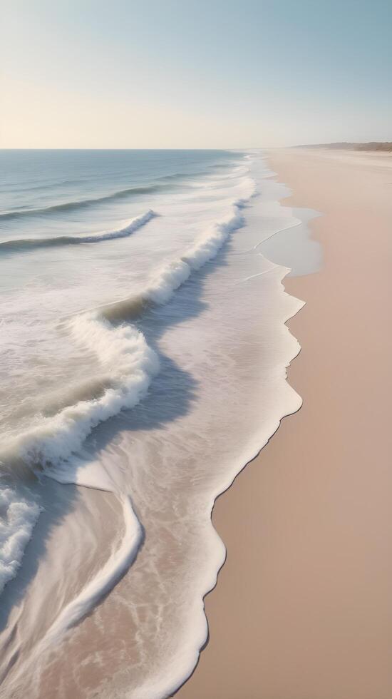 A calm vertical view of a tranquil beach, with smooth waves lapping at the sand, pastel tones, and a sky perfect for copy placement. photo