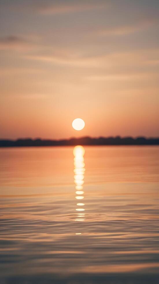 A vertical composition of soft sunset hues reflecting on quiet water, evoking calmness with open space for text. photo