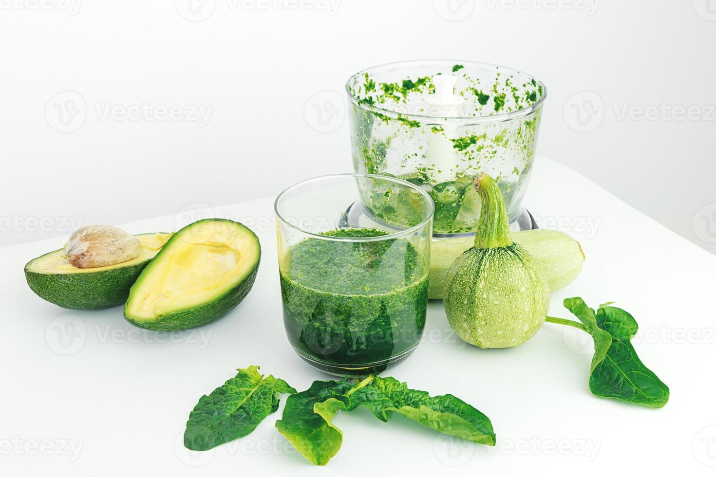 avocado, spinach, zucchini and blender on white background photo