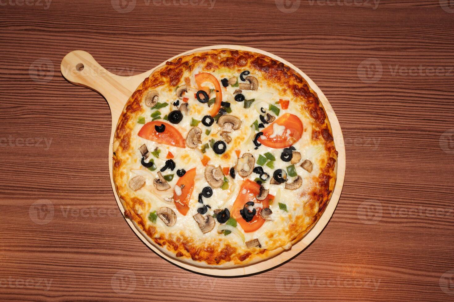 Vegetarian pizza on wooden background photo