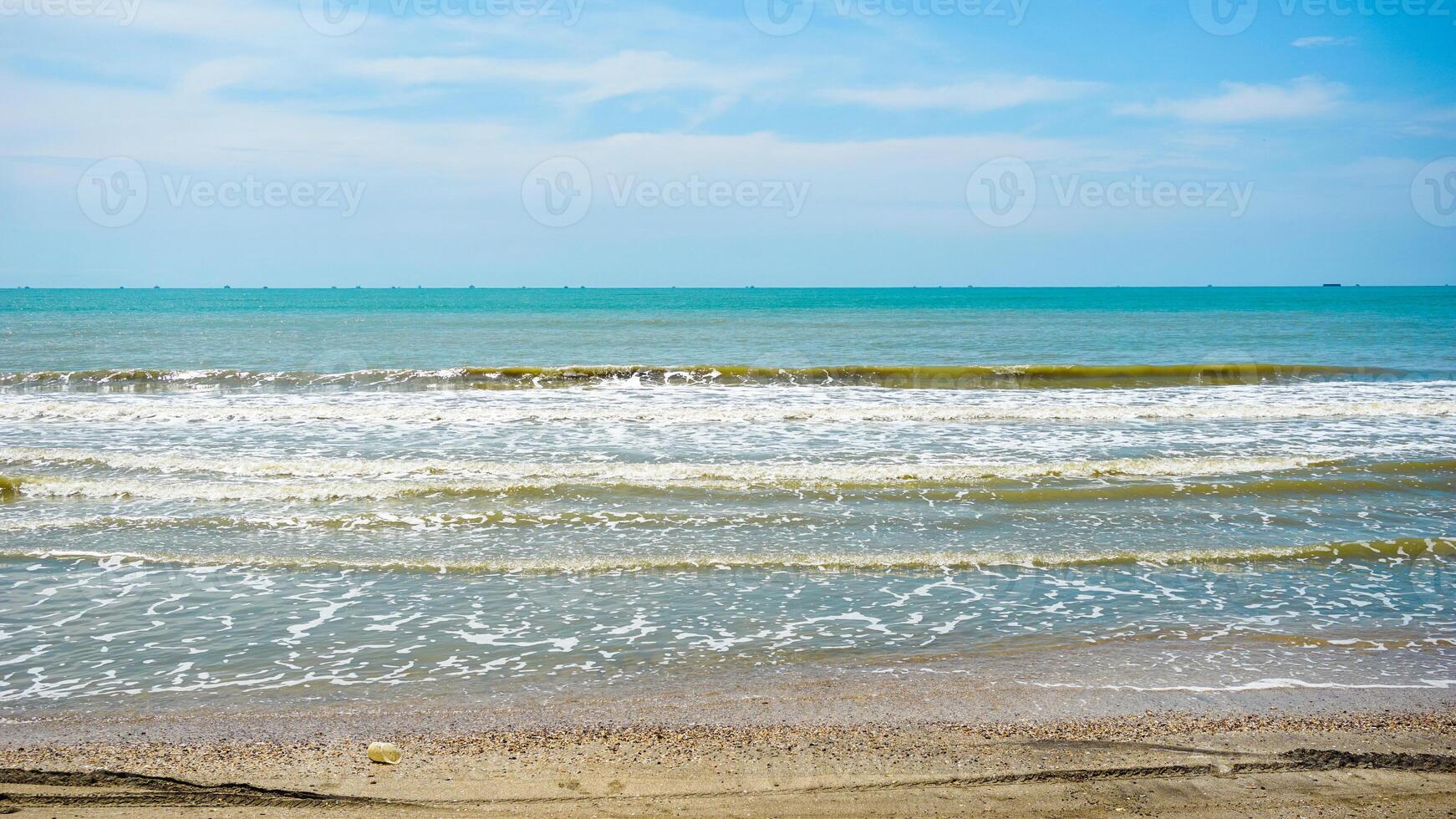 Tranquil Beach with Gentle Waves and Clear Sky photo