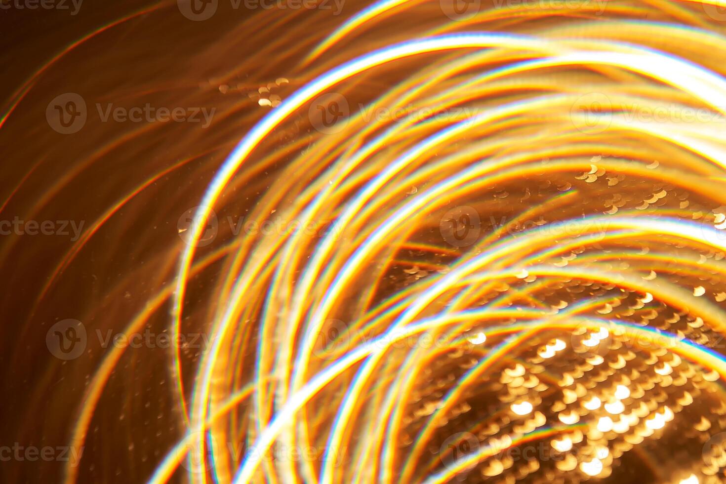 Abstract festive golden background with bright lines of light. photo