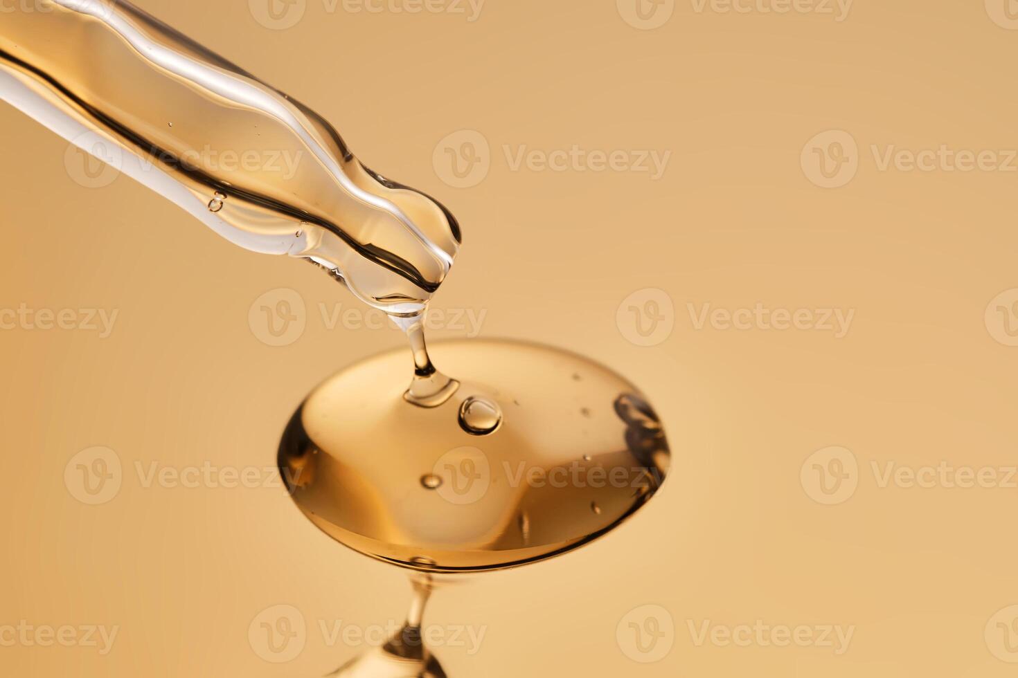 A pipette with a beautiful drop of gel-textured facial serum. photo