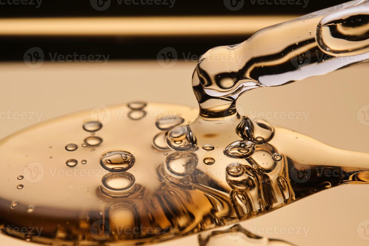 A pipette with a beautiful drop of gel-textured facial serum. photo