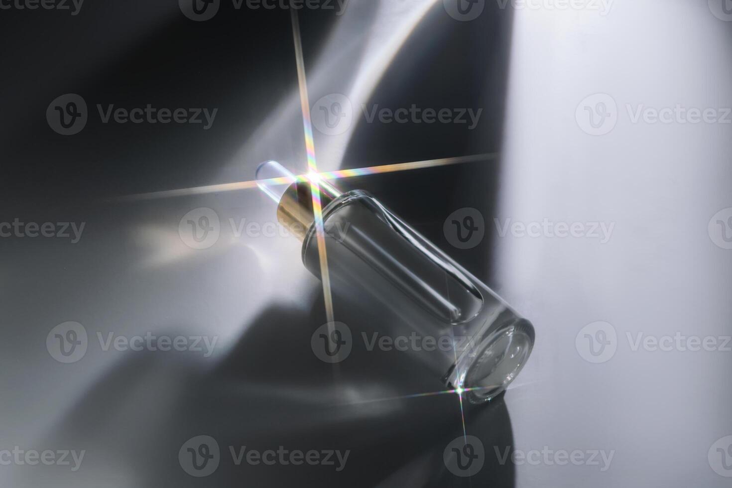 Bottle of face serum with a beautiful highlight. photo